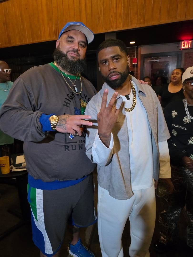 Billy Sorrells throwing up a peace sign with a fan at the Comedy Catch